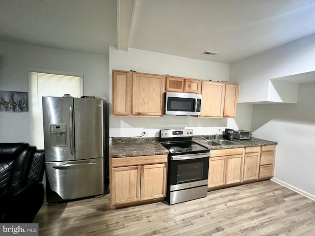 kitchen with light hardwood / wood-style floors, light brown cabinetry, sink, and appliances with stainless steel finishes