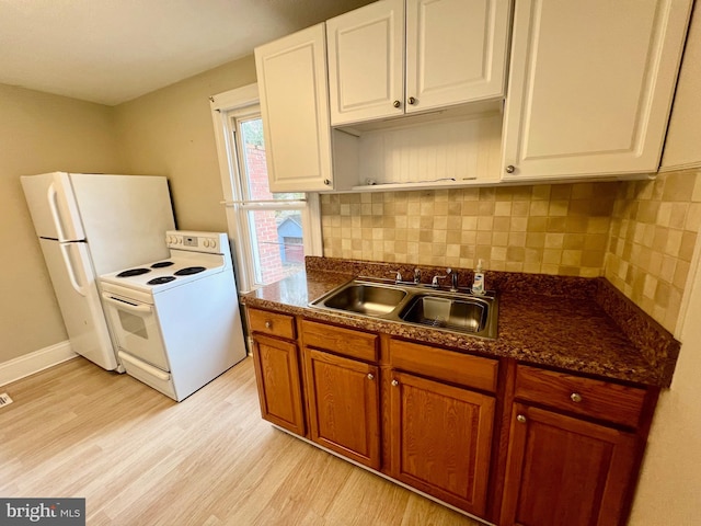 kitchen featuring sink, tasteful backsplash, white appliances, white cabinets, and light wood-type flooring