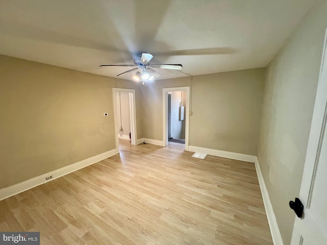 spare room with ceiling fan and light hardwood / wood-style floors