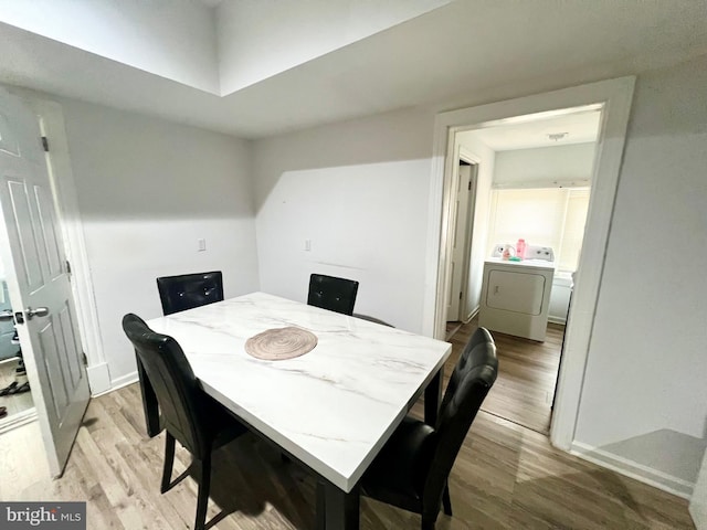 dining area featuring light hardwood / wood-style floors and washer / dryer