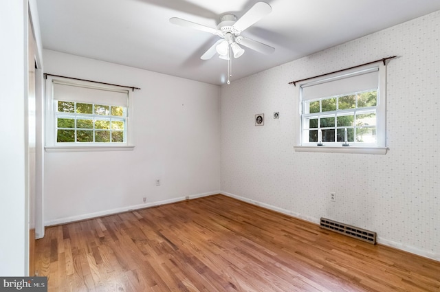 spare room with light wood-type flooring and ceiling fan