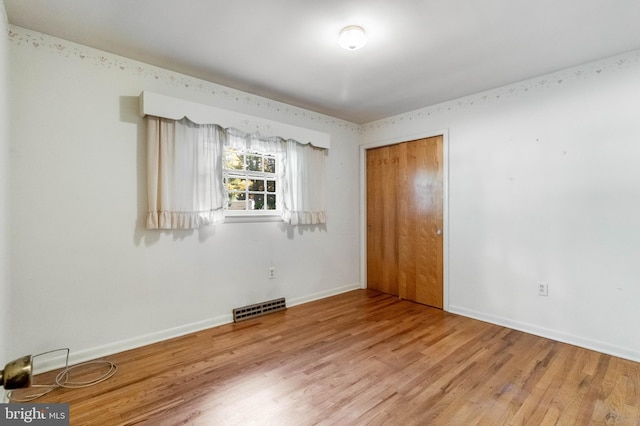 spare room featuring hardwood / wood-style flooring