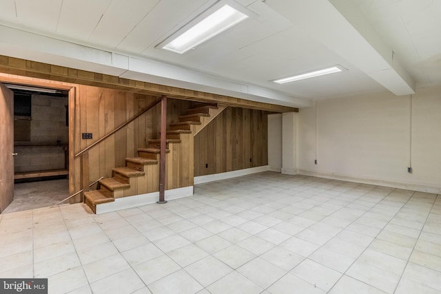 basement featuring wood walls