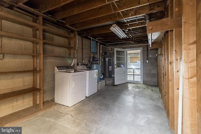 basement featuring water heater and independent washer and dryer