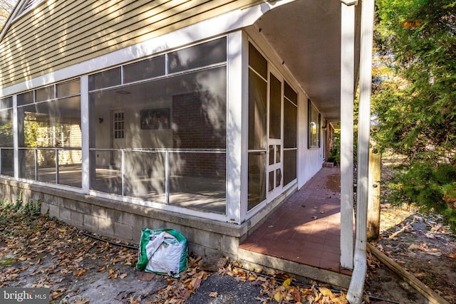 view of side of property featuring a sunroom