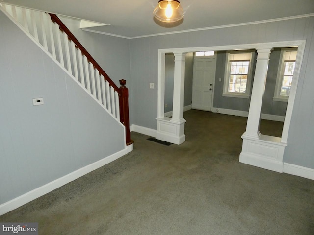 carpeted foyer entrance featuring ornamental molding