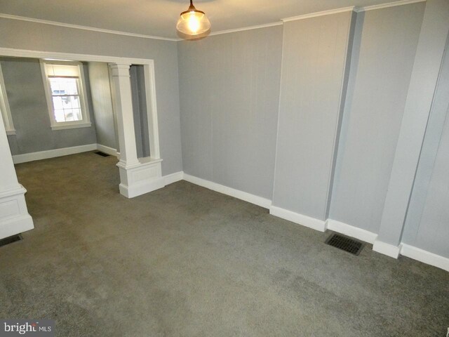 unfurnished bedroom with ornamental molding, dark colored carpet, and ornate columns