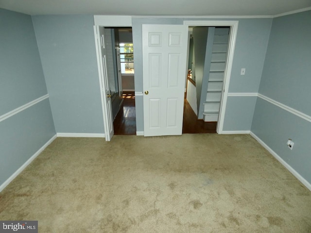 unfurnished bedroom with carpet flooring and ornamental molding