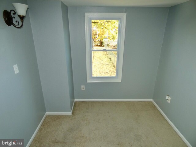 unfurnished room with light carpet