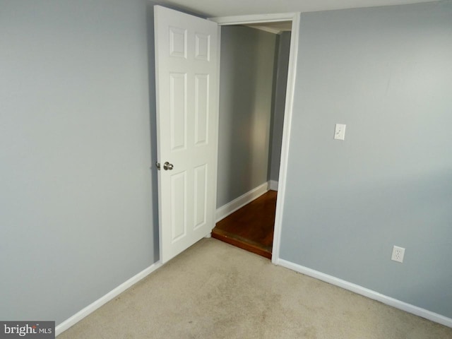 empty room featuring light carpet