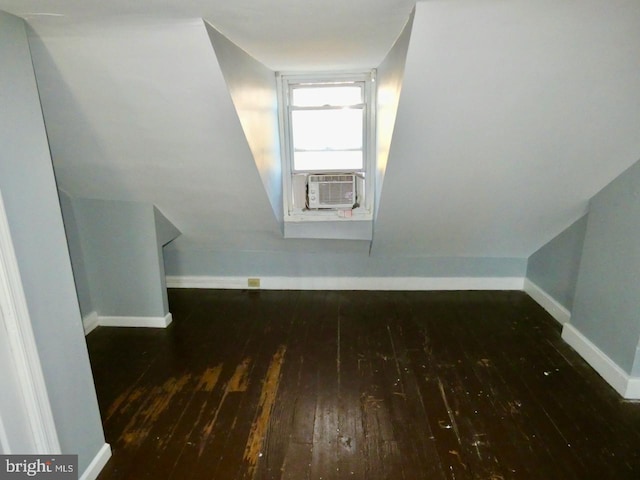 additional living space with dark wood-type flooring, cooling unit, and vaulted ceiling