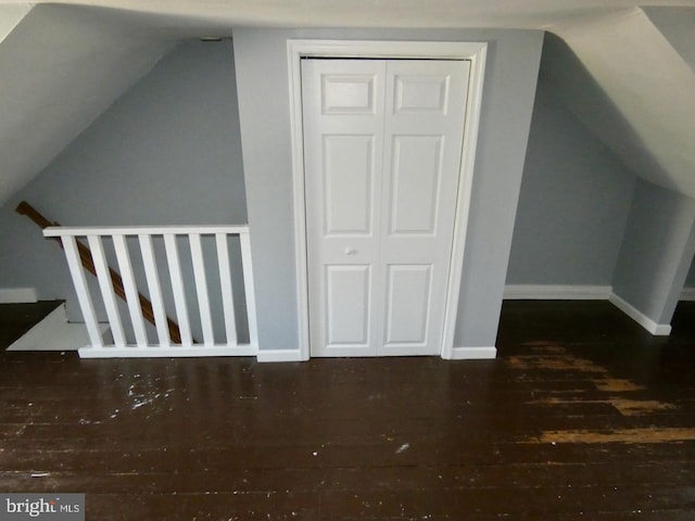 bonus room featuring lofted ceiling and dark wood-type flooring