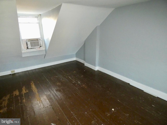 additional living space featuring cooling unit, vaulted ceiling, and dark hardwood / wood-style floors