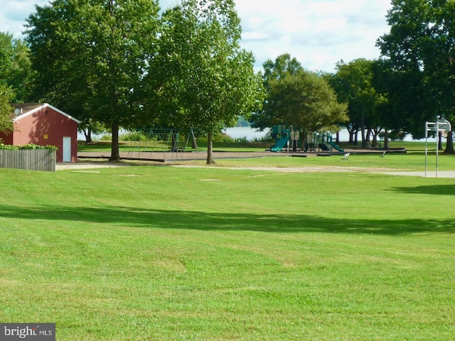 view of home's community with a lawn and a playground