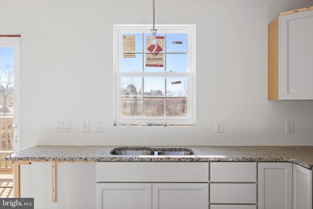 kitchen with pendant lighting and white cabinetry