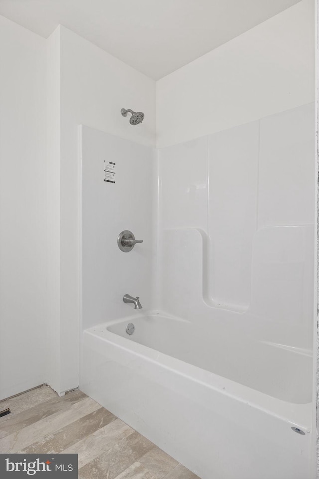 bathroom featuring hardwood / wood-style floors and shower / bathtub combination