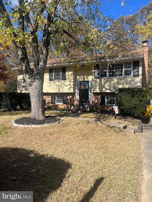 raised ranch featuring a front yard