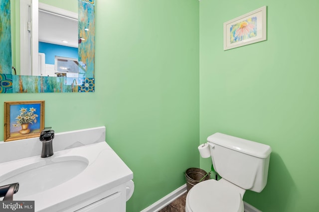 bathroom featuring vanity and toilet