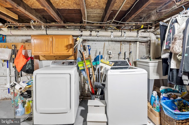 washroom with washer and clothes dryer and cabinets