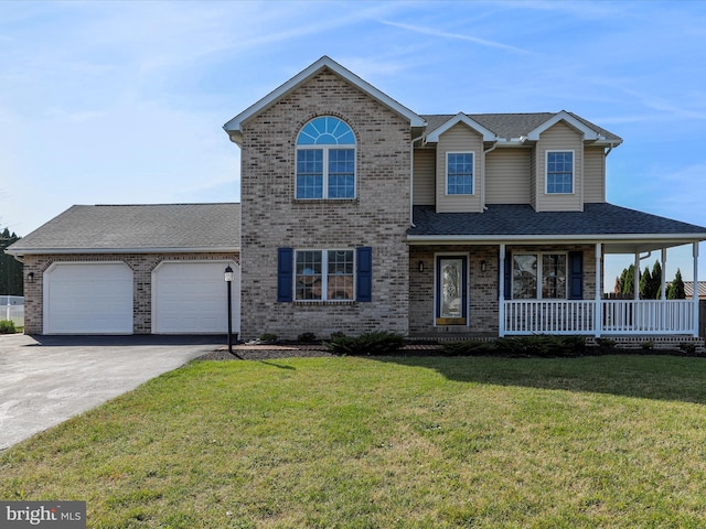 view of front of house with covered porch, a garage, and a front yard