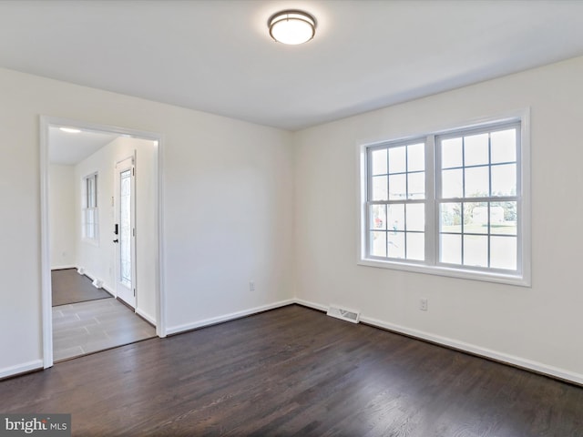 unfurnished room featuring dark wood-type flooring