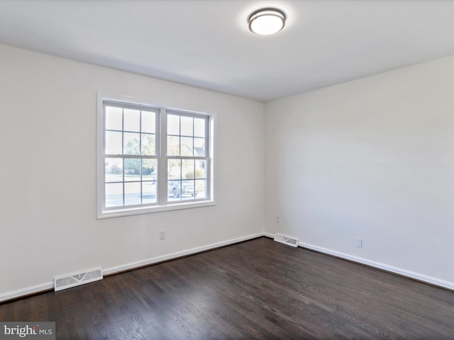 spare room featuring dark hardwood / wood-style flooring