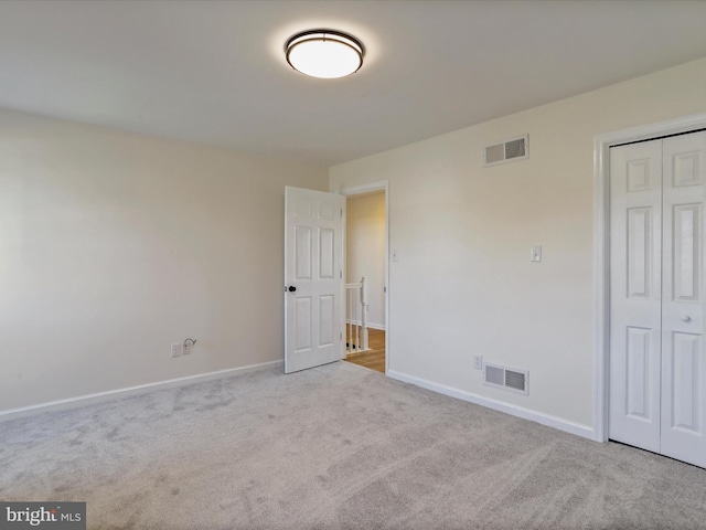 empty room featuring light carpet