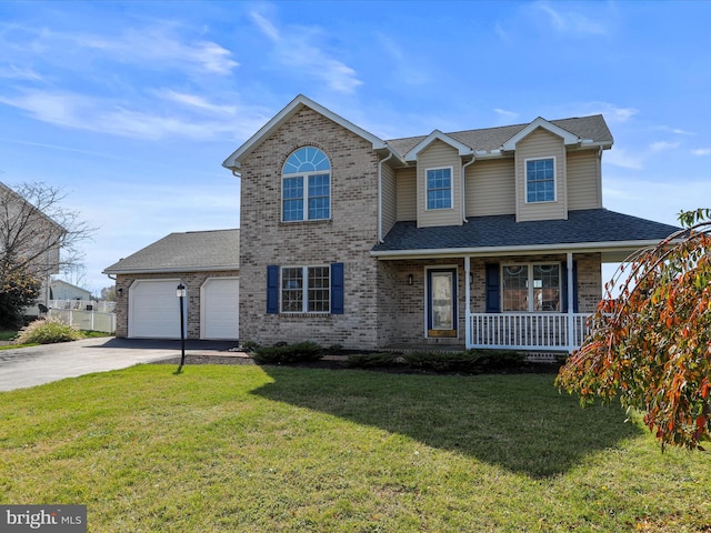 view of front of home featuring a garage, a front lawn, and a porch