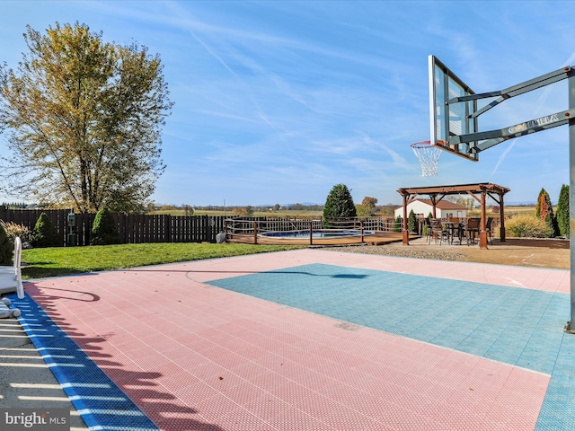 view of pool with a yard and basketball hoop