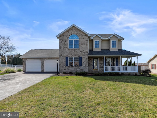 view of front facade featuring a front lawn, covered porch, and a garage