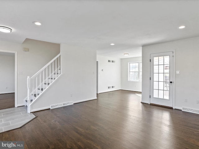 unfurnished living room with dark hardwood / wood-style flooring