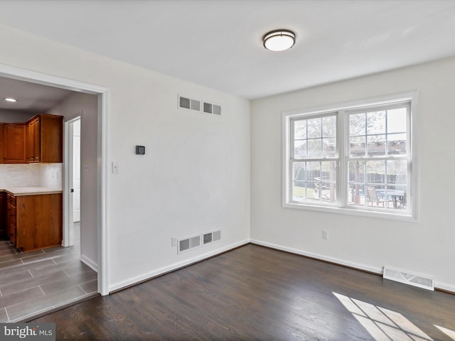 unfurnished room featuring dark hardwood / wood-style floors