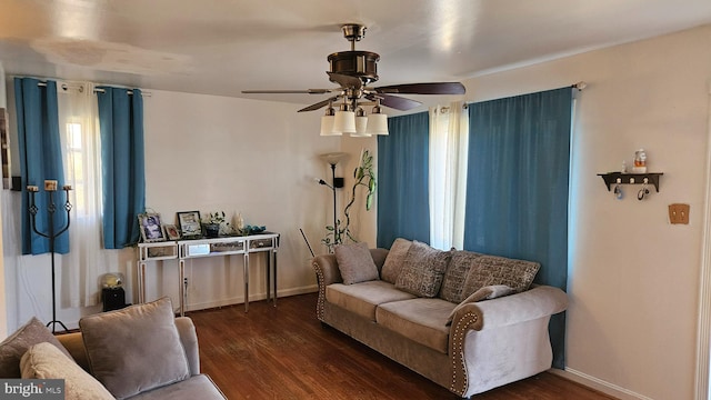 living room featuring ceiling fan and dark hardwood / wood-style flooring