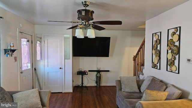 living room with dark hardwood / wood-style floors and ceiling fan