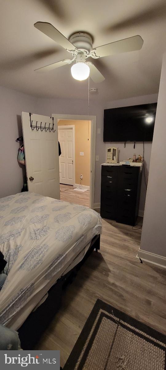 bedroom with hardwood / wood-style floors and ceiling fan