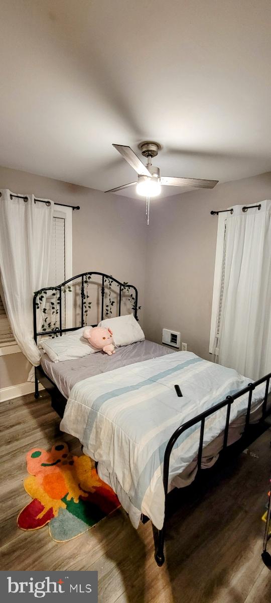 bedroom with ceiling fan and wood-type flooring