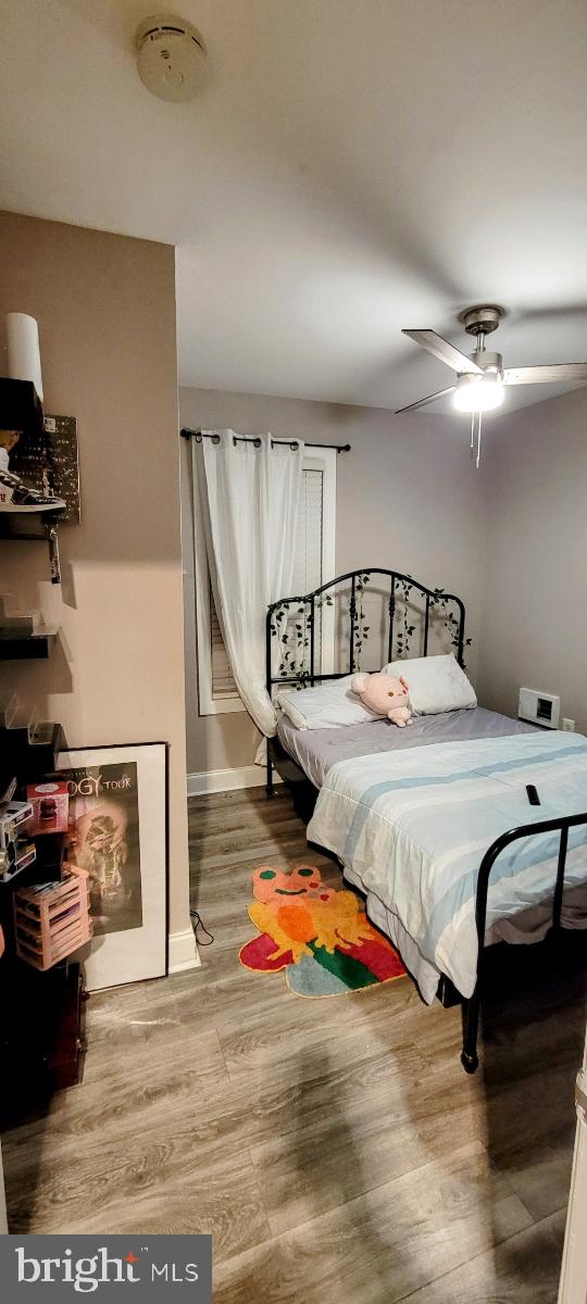 bedroom with wood-type flooring and ceiling fan