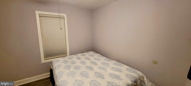 bedroom featuring a closet and dark wood-type flooring