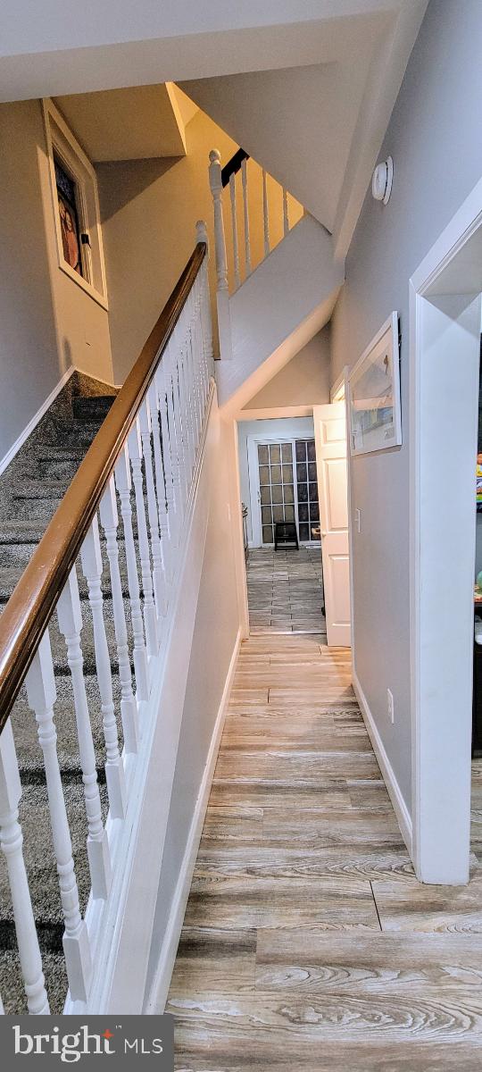 stairs with hardwood / wood-style floors