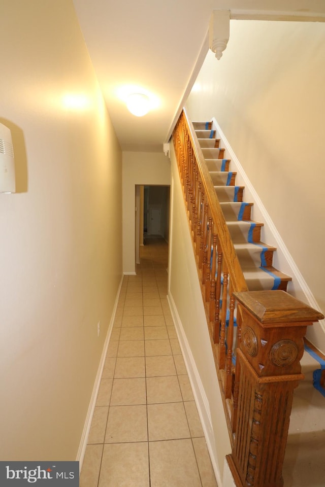 stairway with tile patterned floors