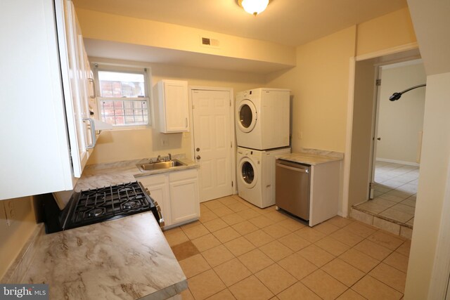 403 O St NW, Washington, DC 20001 - clothes washing area featuring a sink, laundry area, visible vents, light tile patterned floors, and stacked washing maching and dryer