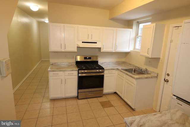 kitchen featuring sink, stainless steel range with gas cooktop, white cabinetry, and light tile patterned floors