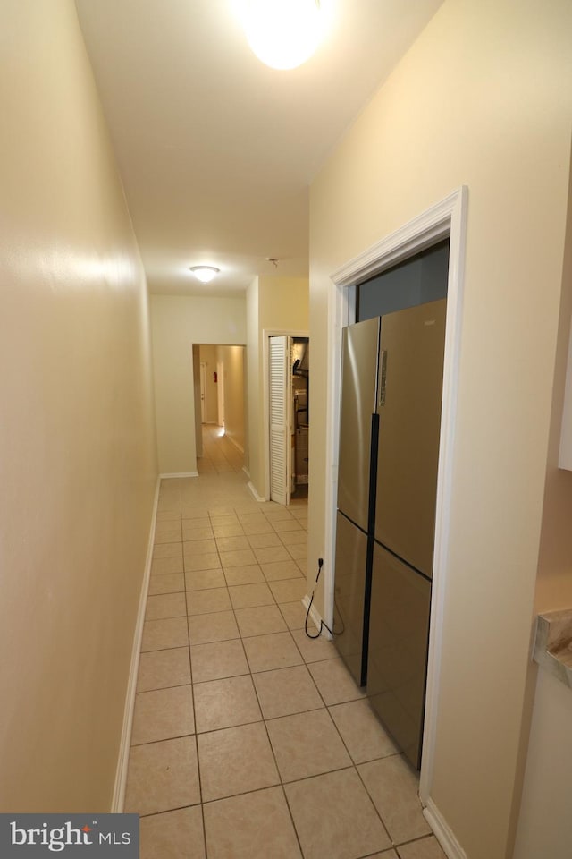 hall with light tile patterned floors