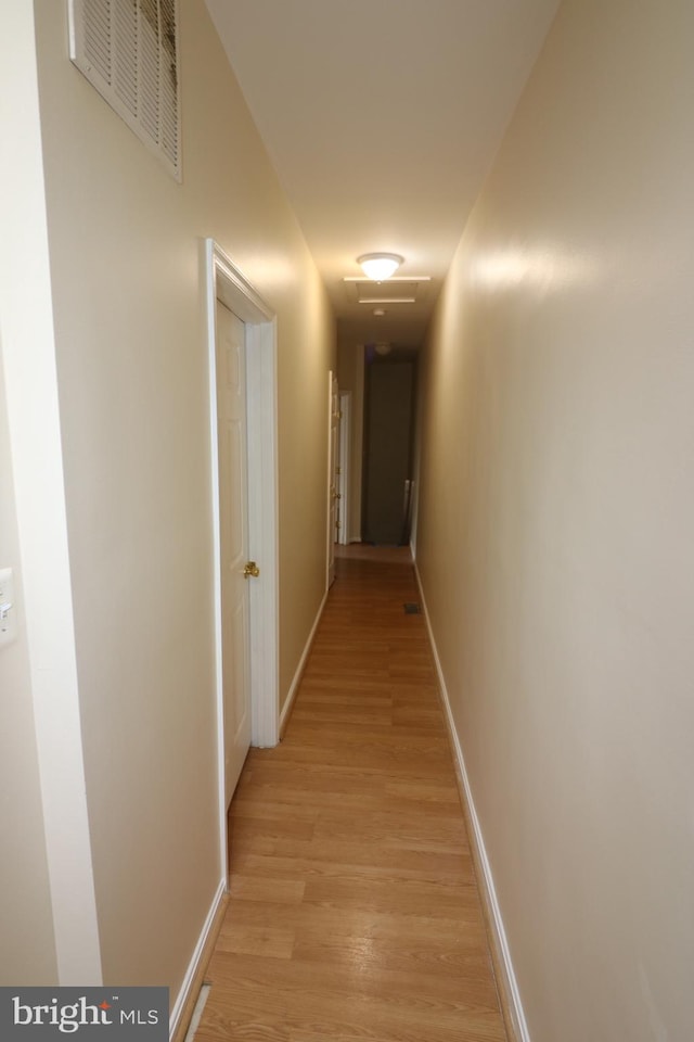 corridor with light hardwood / wood-style flooring