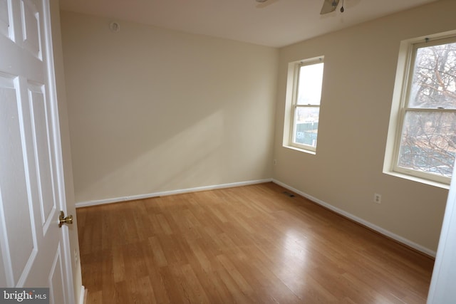 empty room with ceiling fan and light wood-type flooring