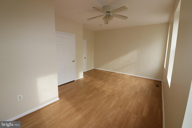 spare room with light wood-type flooring and ceiling fan