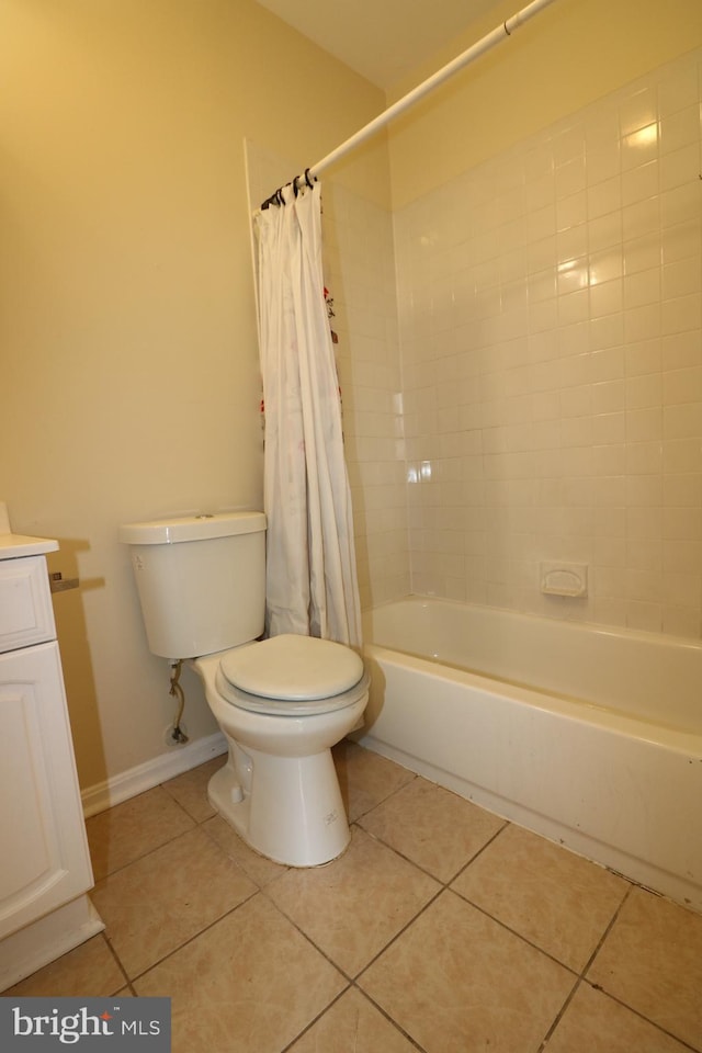 full bathroom featuring vanity, shower / bath combo with shower curtain, toilet, and tile patterned flooring