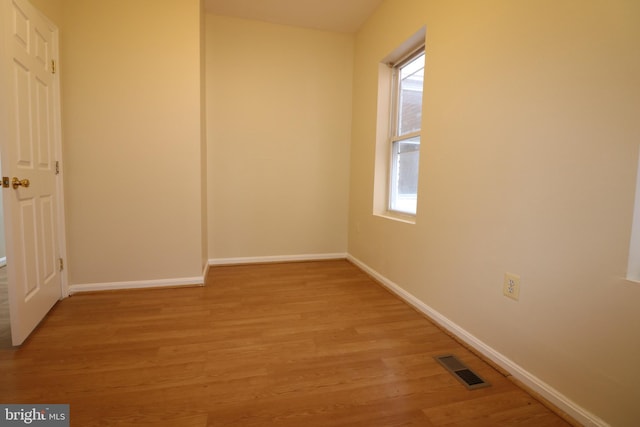 empty room with light hardwood / wood-style flooring