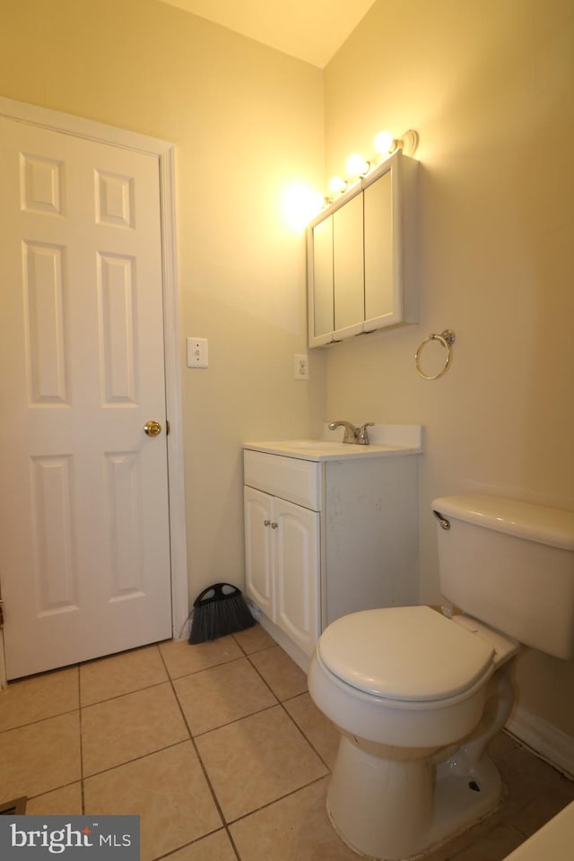 bathroom featuring vanity, toilet, and tile patterned floors