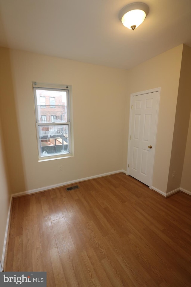 unfurnished room featuring wood-type flooring